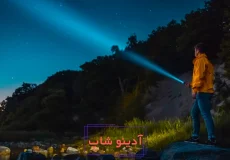 فردی با چراغ قوه در شب