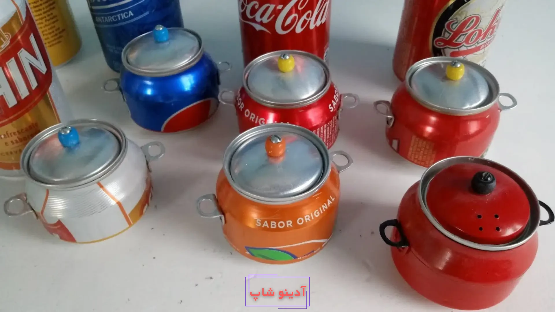 مجموعه‌ای از قابلمه‌های مینیاتوری دست‌ساز رنگارنگ ساخته شده با بازیافت قوطی‌های فلزی نوشابه